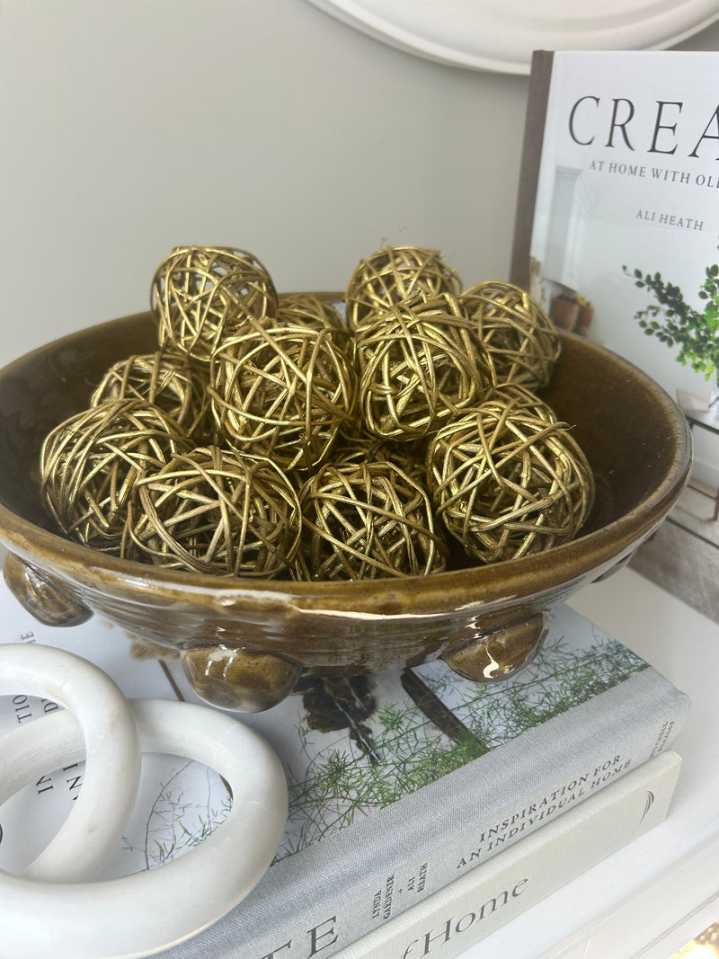 Woven gold balls in bag